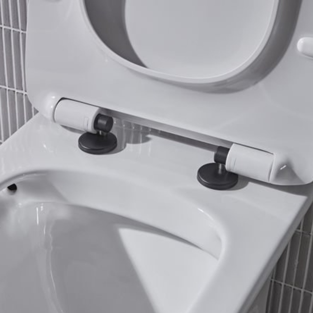 Lifestyle image of the Tavistock Loft Black Wrap Over Toilet Seat Hinge Cover Caps